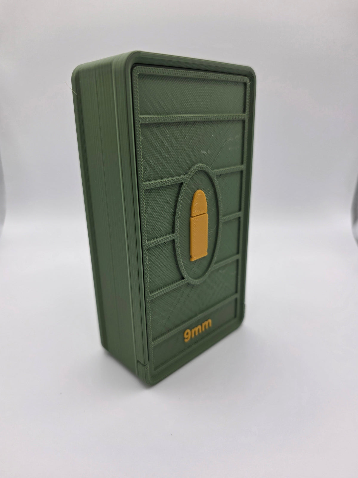 Angled side view of closed olive green 9mm ammo storage box