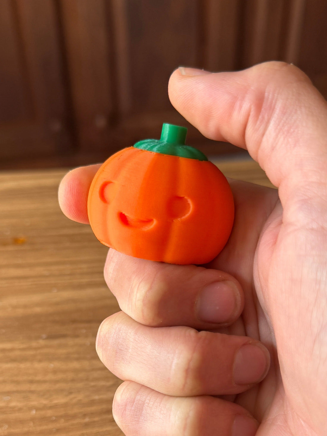 Pumpkin fidget clicker with a keyboard switch, held in hand