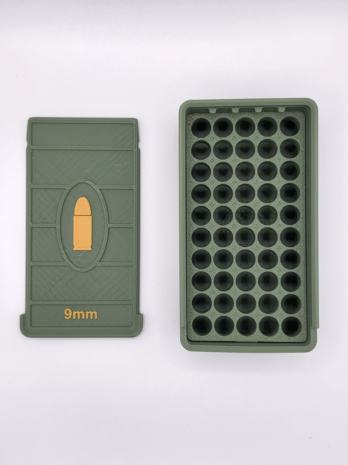 Open olive green 9mm ammo storage box showing 50 empty slots