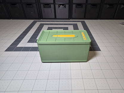 Angled view of closed 5.56 NATO ammo storage case lid with yellow cartridge icon and 5.56 NATO side text, 3D printed by SquigglePrintz