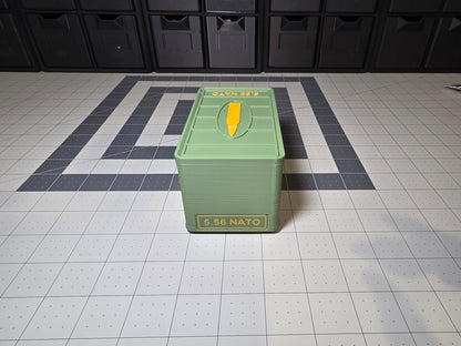 Front view of closed 5.56 NATO ammo storage case with 5.56 NATO label on the front and cartridge icon on the lid, 3D printed by SquigglePrintz