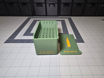 Open 5.56 NATO ammo storage case showing the 50-round cartridge hole grid base beside the removable 5.56 NATO lid, 3D printed by SquigglePrintz