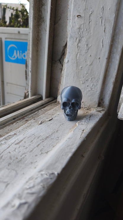 Small skull fidget clicker with a mechanical keyboard switch in the jaw, 3D printed