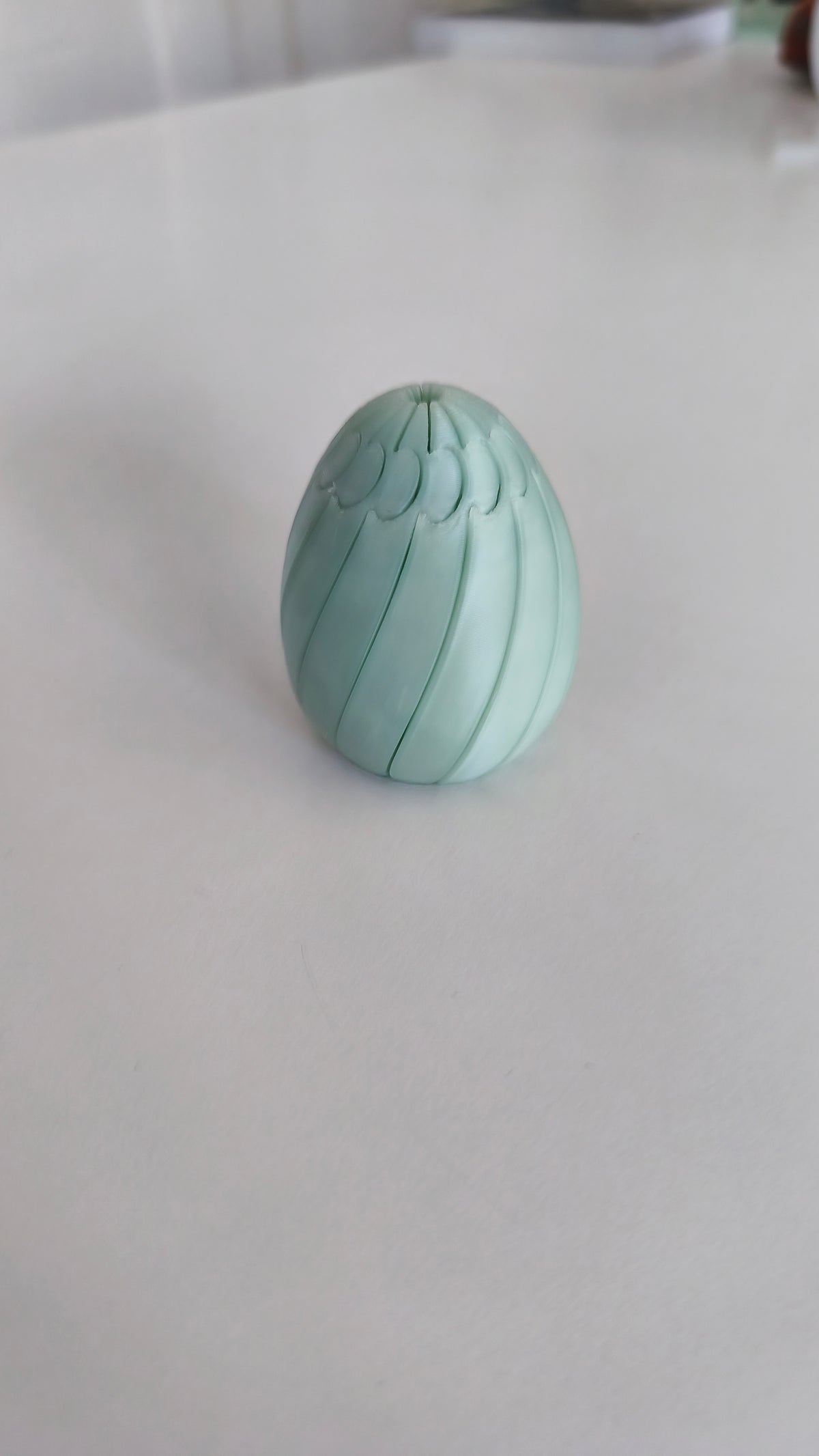 Easter egg slime fidget held in hand for scale.