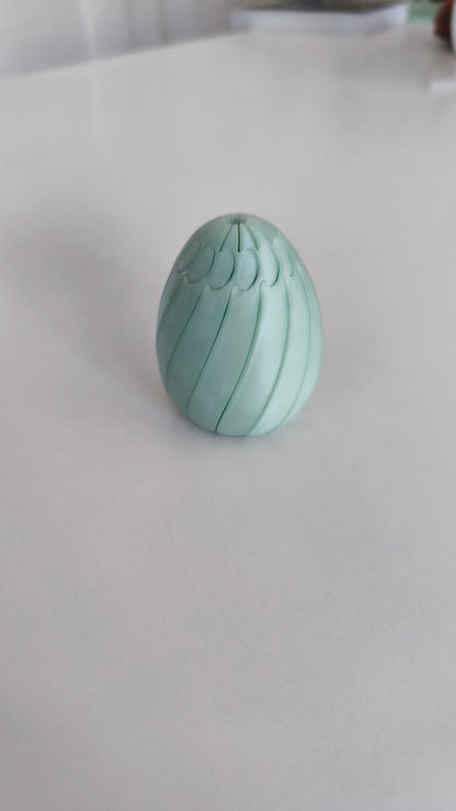 Easter egg slime fidget held in hand for scale.