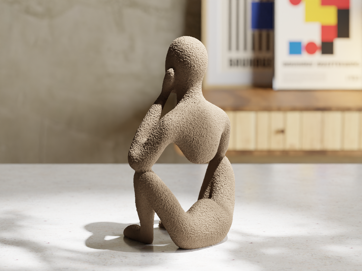 Introspection sculpture shown on a desk.