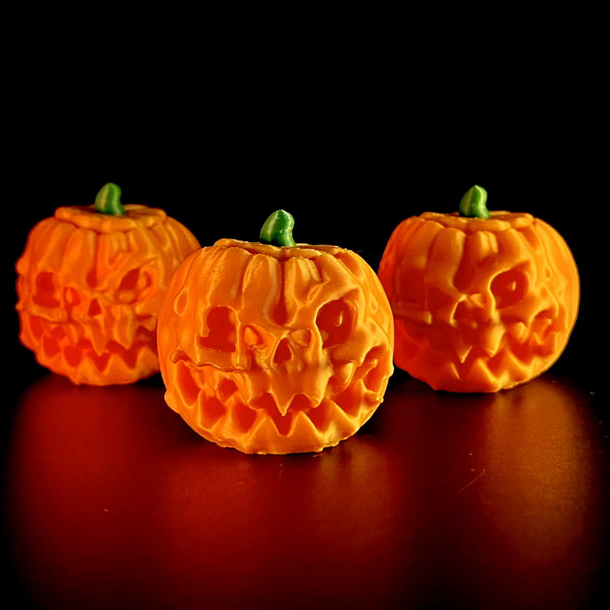 Carved pumpkin fidget clicker, 3D printed Halloween desk toy. Design by Click Bait.