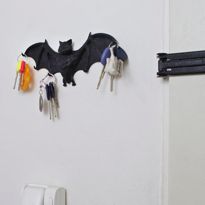 Batki key hanger mounted on a wall with keys. Design by 3D Shook.