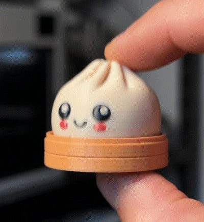 Dumpling fidget clicker with a pleated multi-colour top and base, 3D printed