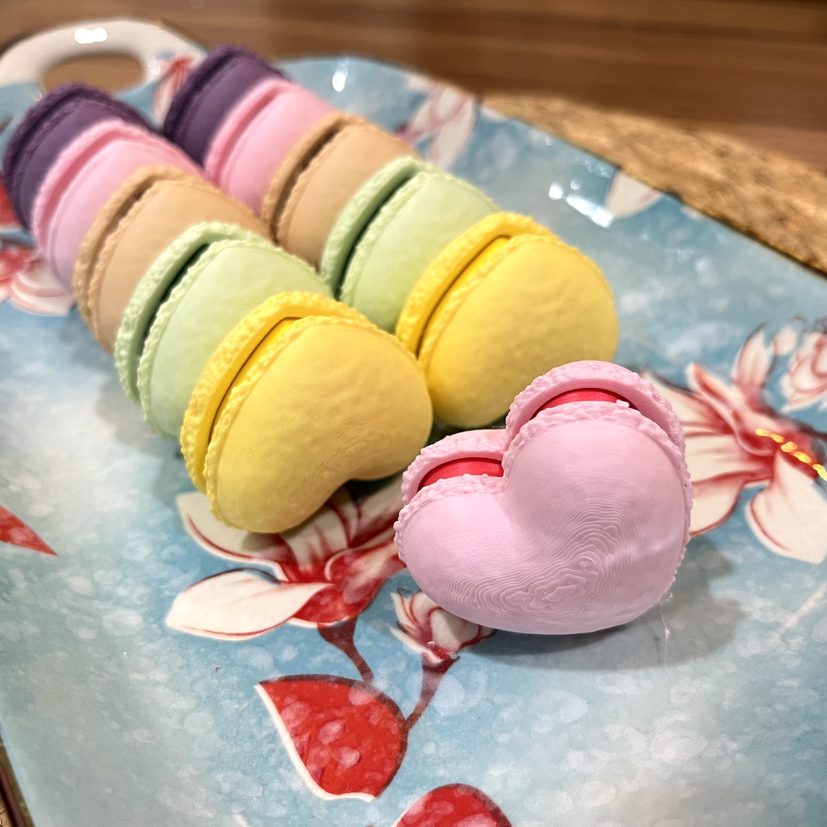 Macaron fidget clicker held in hand for scale.