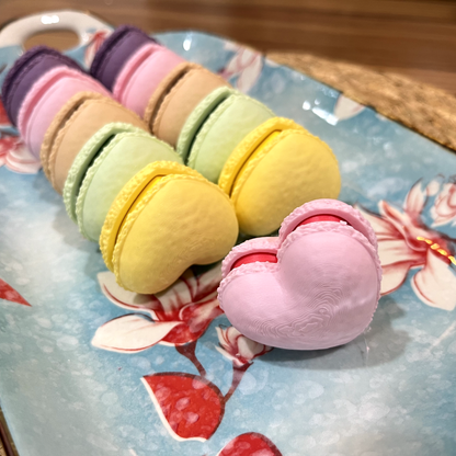 Macaron fidget clicker held in hand for scale.