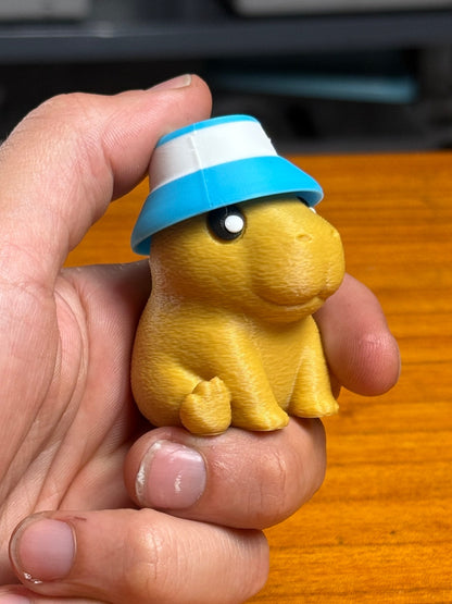 Capybara clicker shown in hand for scale.