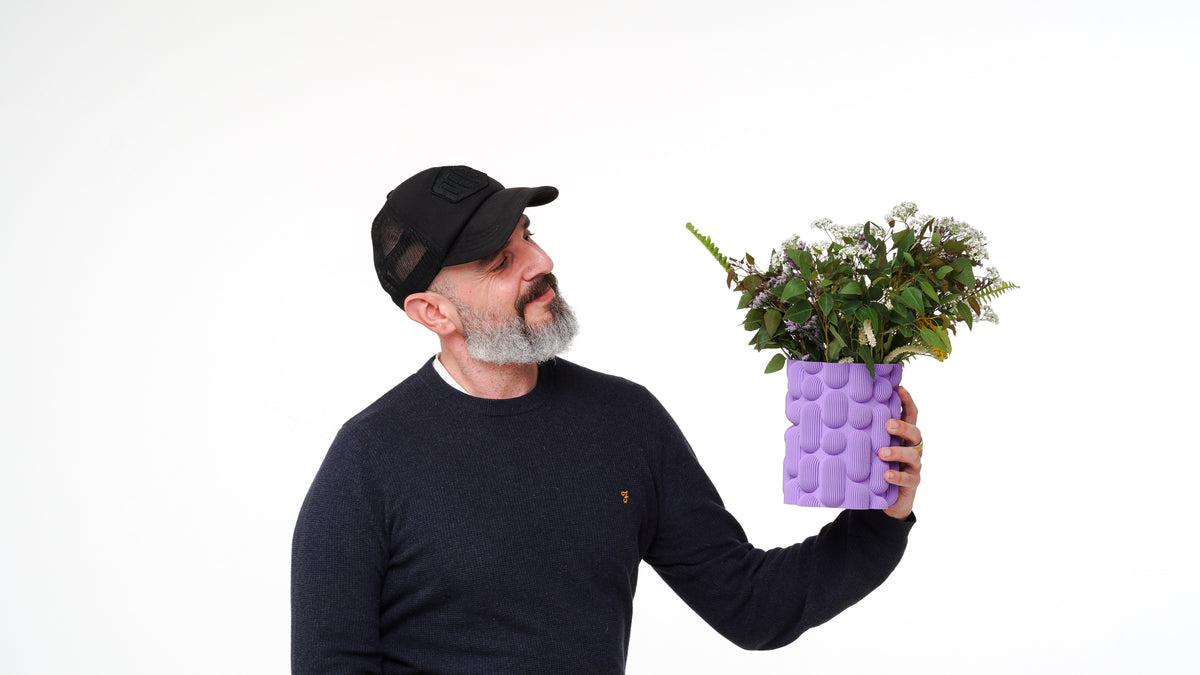Lava vase shown with flowers.