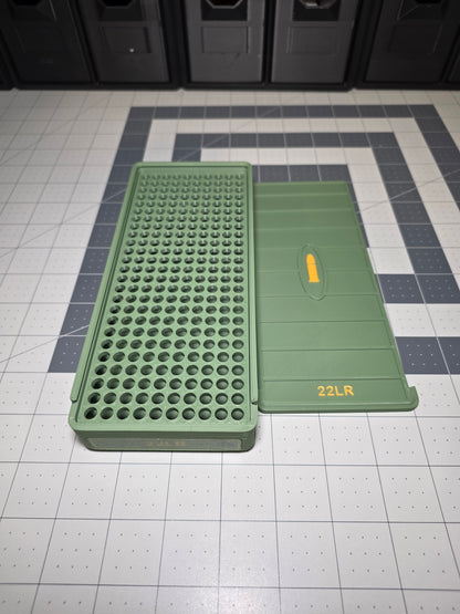 Open .22LR ammo storage box from a side angle showing the cartridge hole grid base and removable 22LR sliding lid, 3D printed by SquigglePrintz