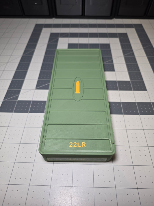 Olive green 3D printed .22LR ammo storage box closed with sliding lid, raised yellow cartridge icon and 22LR label, by SquigglePrintz